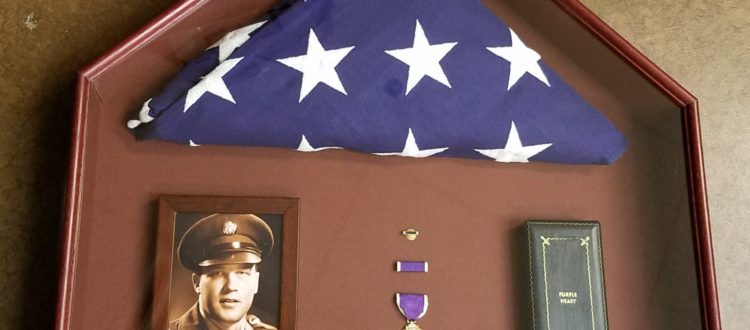 Shadow box of purple heart and flag